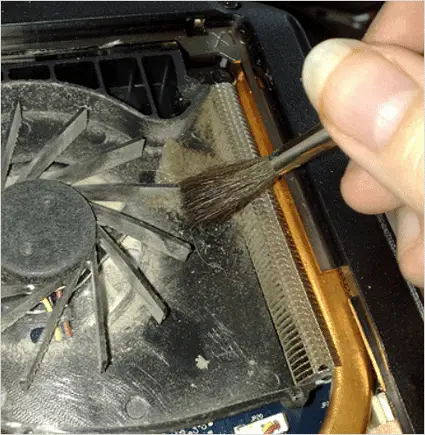 Cleaning dust in laptop fan.